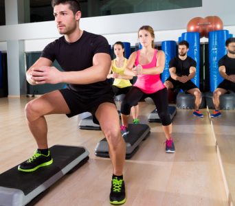 Cardio step dance squat group at fitness gym Cardio step dance squat people group at fitness gym training workout