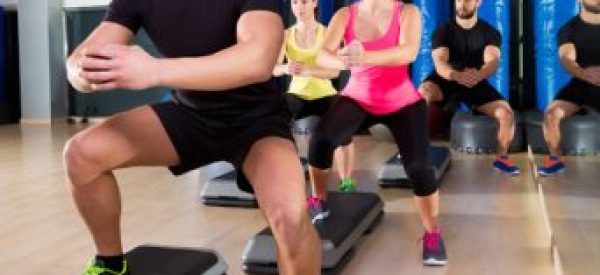Cardio step dance squat group at fitness gym Cardio step dance squat people group at fitness gym training workout