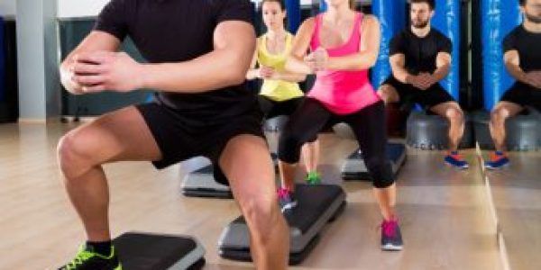 Cardio step dance squat group at fitness gym Cardio step dance squat people group at fitness gym training workout