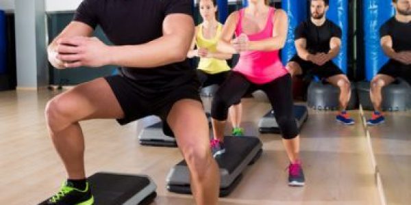 Cardio step dance squat group at fitness gym Cardio step dance squat people group at fitness gym training workout